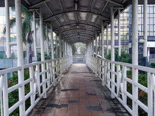 empty pedestrian bridge corridor  that connects side walk 