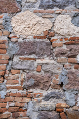 Historic stone wall. rough, old and worn ancient surface. big rock pieces.