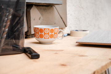 Coffee or tea cup at construction site. A short break from the workforce