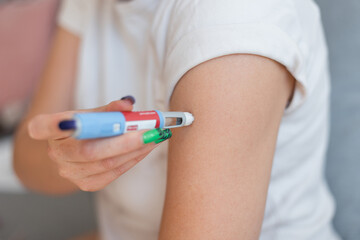 fat girl injects the drug Ozempic into her arm for weight loss at home. Weight loss and treatment...