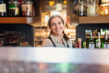 barwoman behind the counter of a cafe
