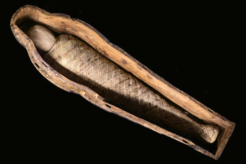 ancient Egyptian mummy in a museum on a dark background