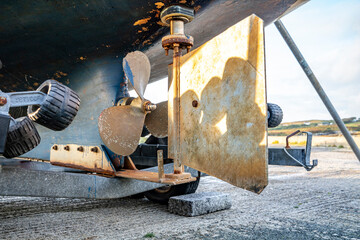 Propeller screw and rudder of vessel at Rosbeg harbour in County Donegal - Ireland.