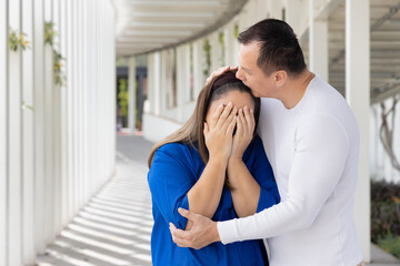 Attentive Middle aged husband taking care of his sad crying wife, concept of Family Lifestyle, caring husband and wife, Family Togetherness, aging society with attentive and caring family members - Powered by Adobe