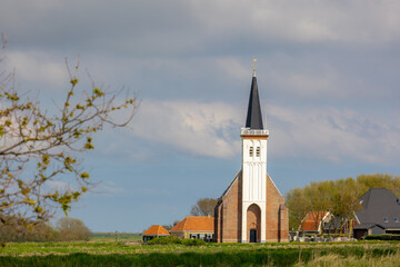 Typical landscape of Texel island with small village and picturesque church (Hervormde kerk) under...