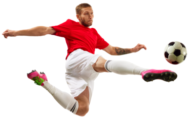 Young soccer soccer player looks confident practicing kicking ball in motion against transparent background. Football school. Concept of game, sport, recreation, active lifestyle.