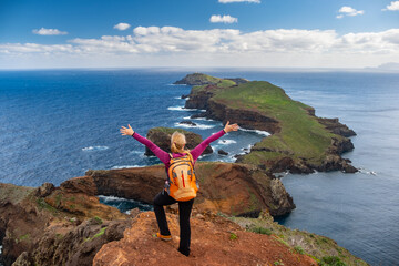 Tourists on hiking path on Ponta de Sao Lourenco Madeira Portugal. Green landscape cliffs and...