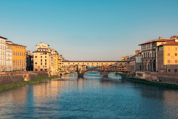 Fototapeta premium View on Ponte Vecchio Bridge in Florence during sunrise in the summertime with copy space