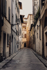 Fototapeta premium Vertical photo of an empty street of the old city center of Florence in the early morning without people
