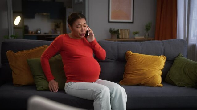 Painful feel bad suffering ache pregnant woman African American female girl problem health trouble home discomfort pain medicine talking mobile phone call seizures need doctor medical help childbirth