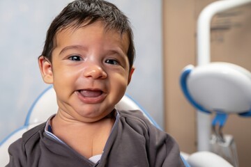Naklejka premium baby sitting on a dentist chair, kid with white teeth in a dental studio, little patient in a clinic, beautiful smile