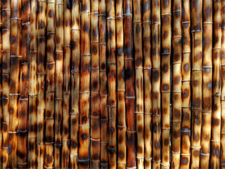 Brown bamboo background wall fence texture, asia traditional pattern. Dark brown color bamboo stick texture background. Bamboo brown tropical texture background as interior or exterior bambu decor