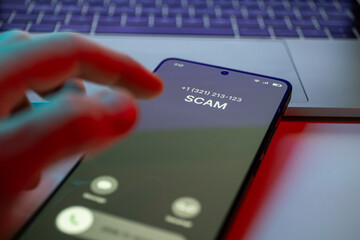 Scam call concept on mobile phone. Person get scam call alert. Phone call from unknown number late...