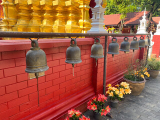 Thai Buddhist Temple wat prayer bells in a row in Chiang Mai Thailand for spiritual acts and...