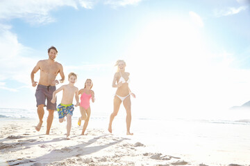 Portrait, beach and family running with happiness, weekend break and bonding together with holiday....