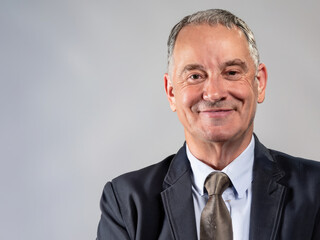portrait of a smiling businessman, ceo looking on camera, photo of a president