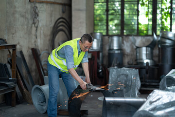 person working with power tool in factory