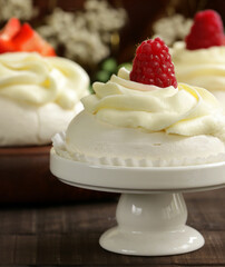 Meringue pavlova cake with berries and butter cream