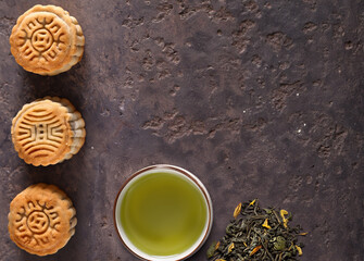 traditional mooncakes and green tea on the table
