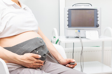 Pregnant woman undergoing CTG monitorning during final weeks of pregnancy