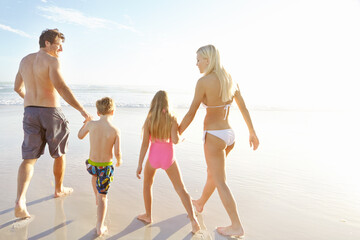 Back, holding hands and sky with family on beach, walking together in summer for bonding or fun. Love, nature or smile with mother, father and kids on sand by ocean or sea for holiday and vacation