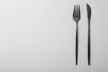 Stylish cutlery on grey table, top view. Space for text