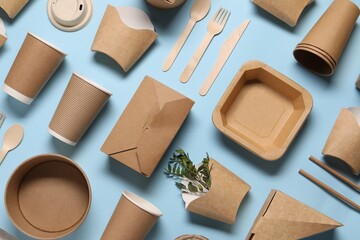 Flat lay composition with eco friendly food packagings and twigs on light blue background