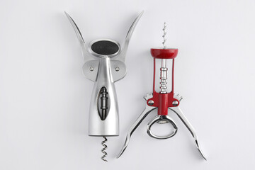 Different corkscrews on white background, flat lay