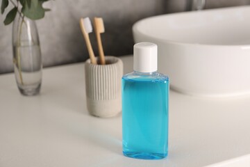 Bottle of mouthwash on white countertop in bathroom
