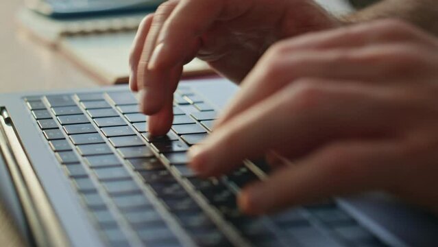 Unrecognizable writer typing keyboard laptop creating article at office close up