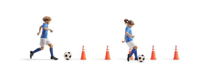 Boy and girl running with footballs between cone obstacles