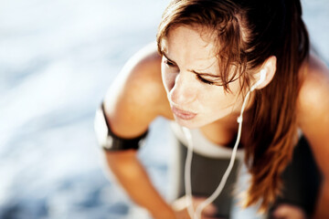 Tired, pain and sports woman outdoor for thinking, breathe or body health at beach. Fatigue,...