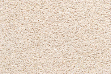 Beige porous plastered wall background, plastered texture