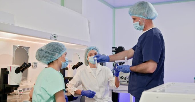 Embryologists in a laboratory conducting artificial fertilization of a human egg using advanced equipment. Professional team engaged in IVF procedures. Embryologists Laboratory Setting