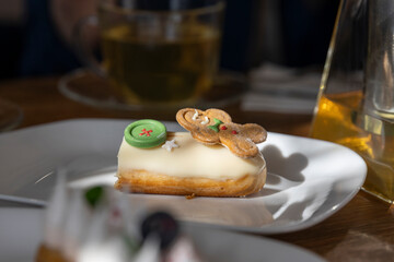 Start your day off right with a white plate filled with delicious pastries next to a glass of wine, creating a perfect morning indulgence.