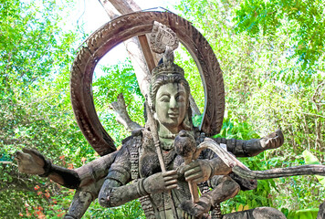 Ancient Buddhist Deity Statue peacefully situated in a natural and serene environment