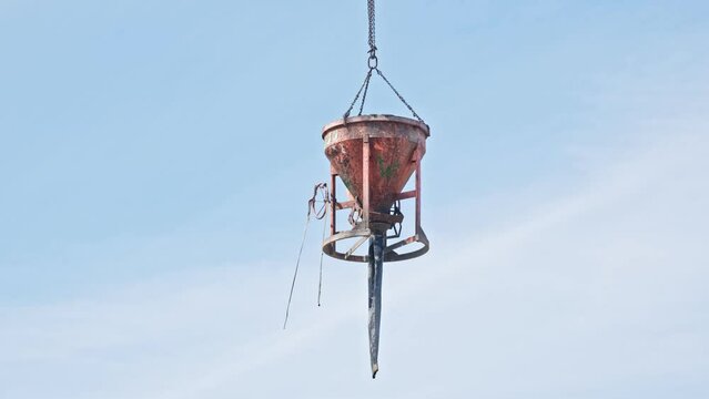 Concrete Funnel Skip for Aiming and Placing Concrete Lifted with Crane over Construction Site