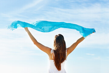 Back, woman and scarf in wind for freedom, calm and wellness on vacation. Female tourist, carefree...