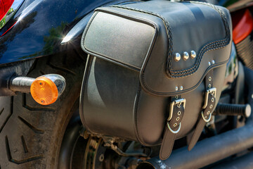 the back of the motorcycle to which the leather luggage bag is attached