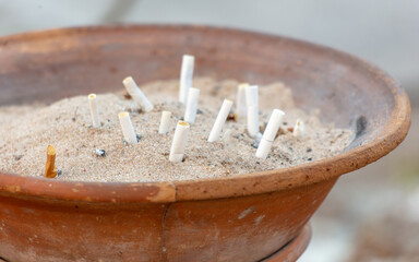 Cigarette butts in a sand bin