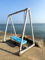 Wooden swing by the sea
