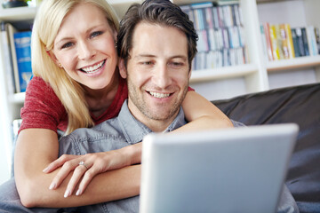 Happy, couple and hugging in living room with tablet, relax online and people smile for internet browse together. Social media, web and scrolling for relationship bonding, networking and apartment