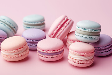 Fototapeta premium Colorful assorted macarons on pink background