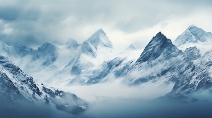 Obraz premium Majestic snow-capped mountains pierce through a sea of clouds.