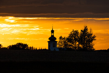 Beautiful sunset and catholic church in the background