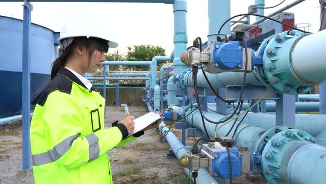 A female engineer working at a water treatment plant, inspecting and maintaining the water supply system, checking chlorine levels, ensuring water quality, and overseeing the dynamo motors and control