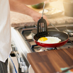 Hands, pan and cooking egg in kitchen for breakfast in home with diet, wellness and nutrition....