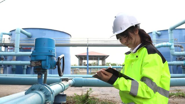 A female engineer working at a water treatment plant, inspecting and maintaining the water supply system, checking chlorine levels, ensuring water quality, and overseeing the dynamo motors and control