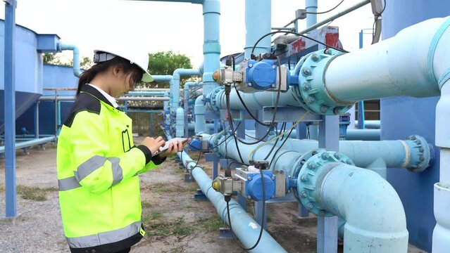 A female engineer working at a water treatment plant, inspecting and maintaining the water supply system, checking chlorine levels, ensuring water quality, and overseeing the dynamo motors and control