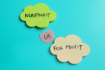 Concept of Nonprofit vs For Profit write on sticky notes isolated on Wooden Table.